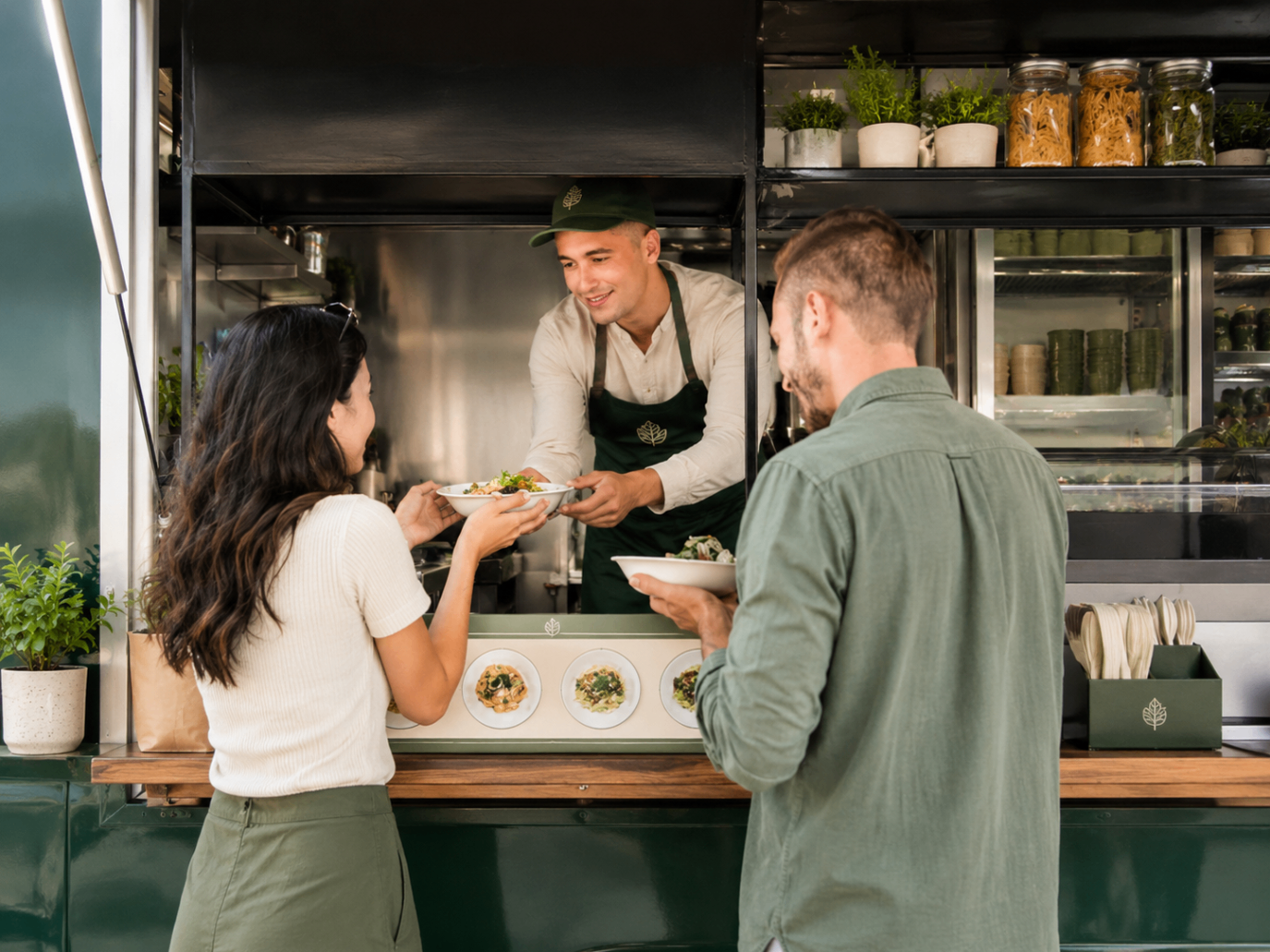 Food truck owner serving a queue of customers at lunchtime